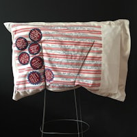 a pillow with red, white and blue stripes on it